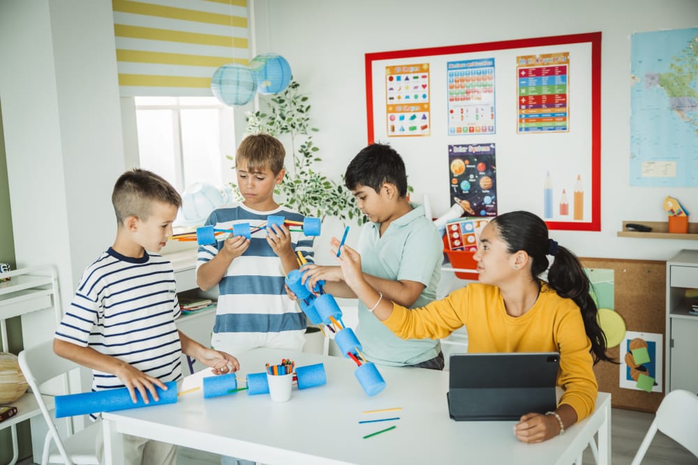 Teacher helping students in the handson STEM class