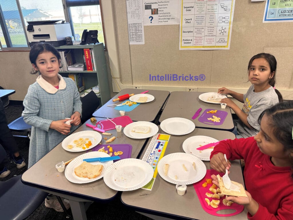 Students practicing measurement and nutrition science while preparing healthy fruit wraps in the STEM Kitchen lab.