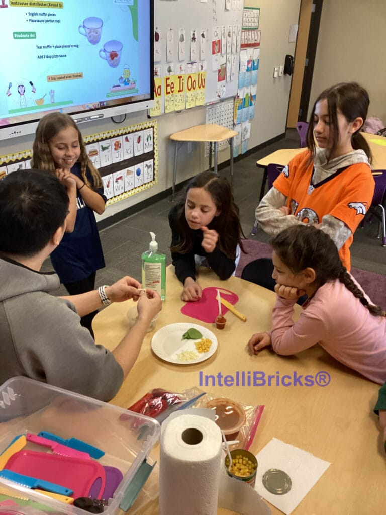 Students gathered around an instructor during a classroom-friendly STEM cooking activity to explore ratios and nutrition.